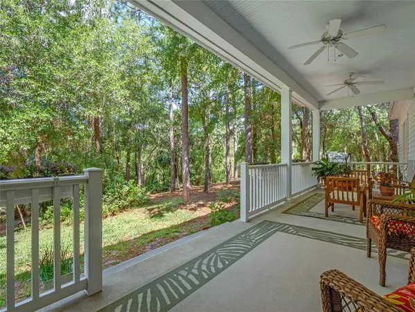 a view of a porch with furniture and a backyard