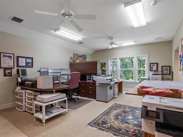 a view of a workspace with furniture and a window