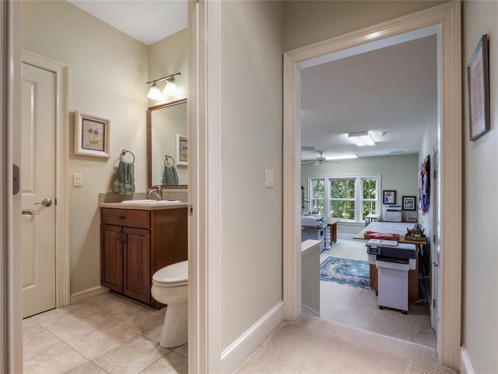 4000 Rouse Road Orlando, FL 32817 - Photo 37 of 53 a room with kitchen island a sink a counter and a living room view