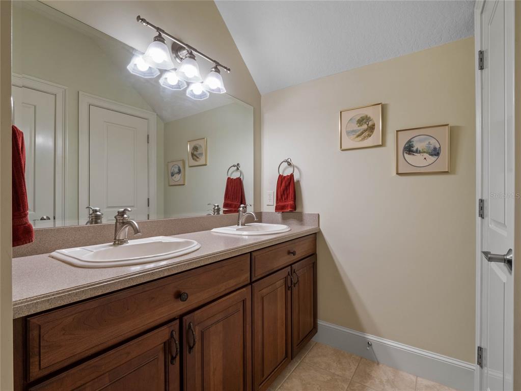 4000 Rouse Road Orlando, FL 32817 - Photo 38 of 53 a bathroom with a double vanity sink and a mirror