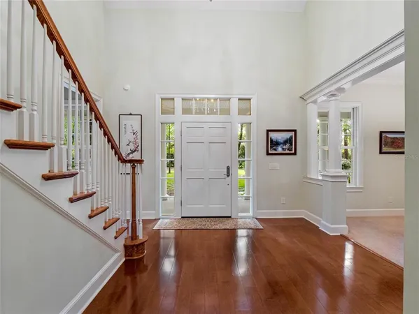 a view of an entryway with wooden floor and stairs