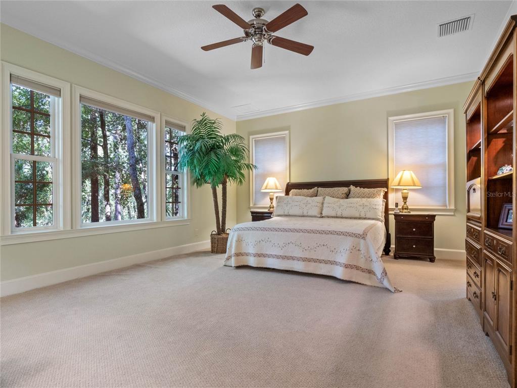 4000 Rouse Road Orlando, FL 32817 - Photo 8 of 53 a bedroom with a large bed and a chandelier fan