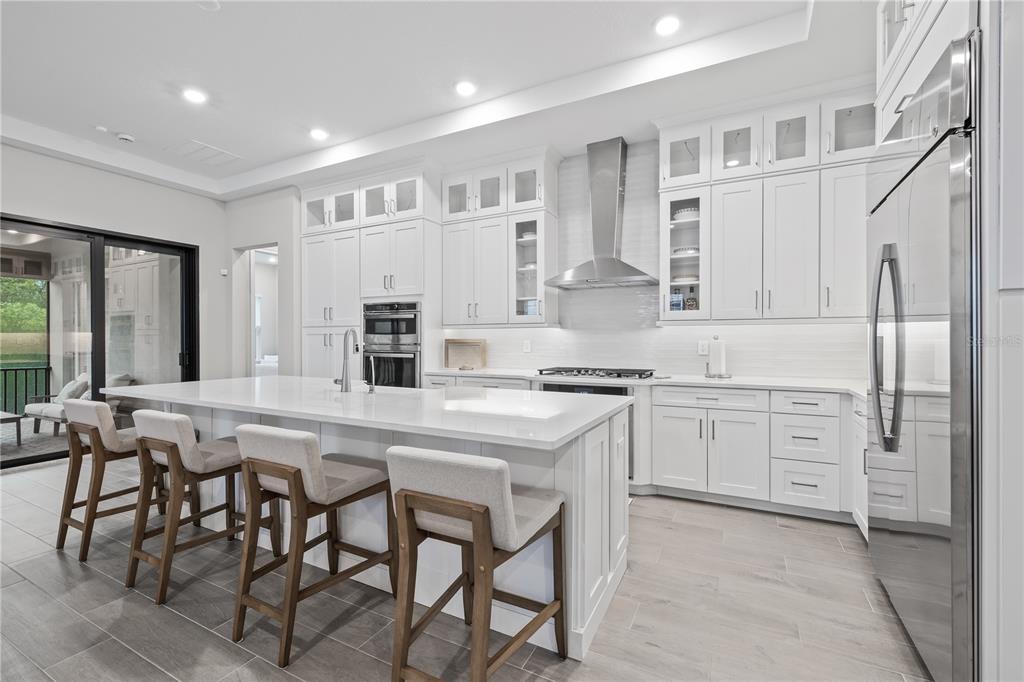 2632 Yellow Sundial Loop Ruskin, FL 33570 - Photo 16 of 52 a kitchen with granite countertop cabinets and chairs