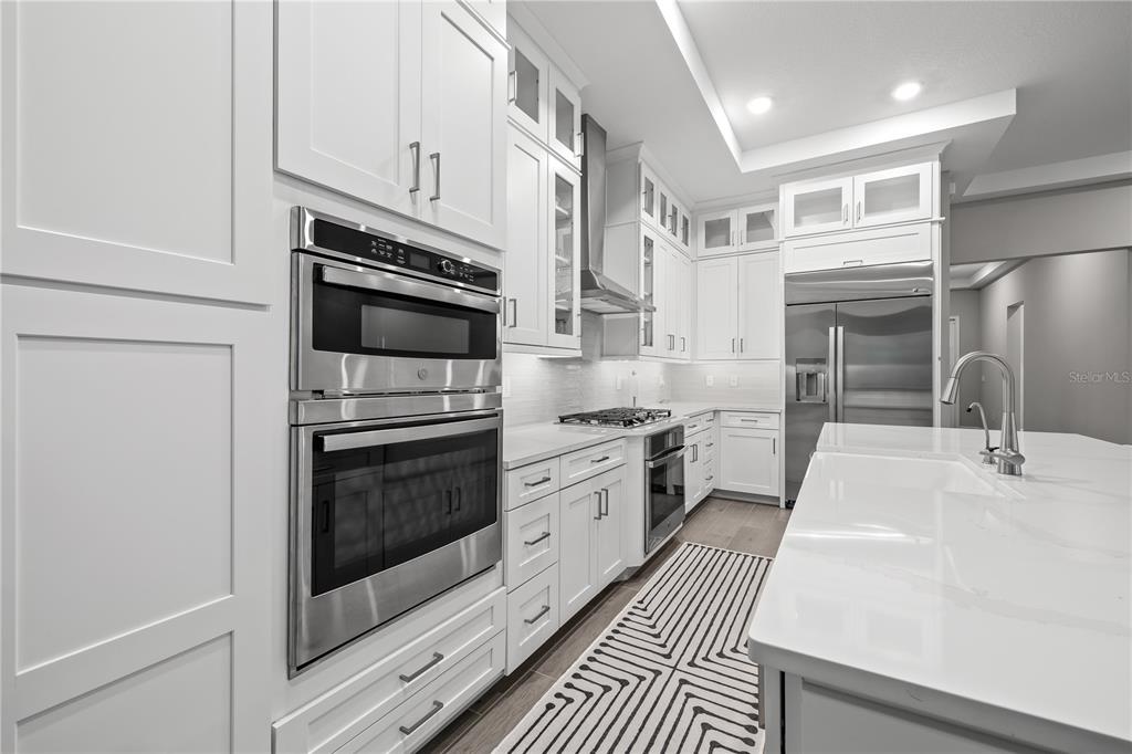 2632 Yellow Sundial Loop Ruskin, FL 33570 - Photo 18 of 52 a kitchen with stainless steel appliances a stove sink and cabinets