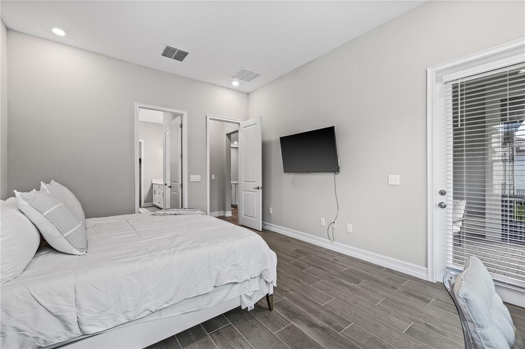 2632 Yellow Sundial Loop Ruskin, FL 33570 - Photo 24 of 52 a spacious bedroom with a bed and a flat screen tv