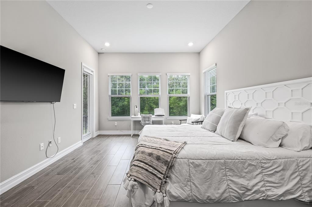 2632 Yellow Sundial Loop Ruskin, FL 33570 - Photo 25 of 52 a bedroom with a large bed and a flat tv screen on dresser