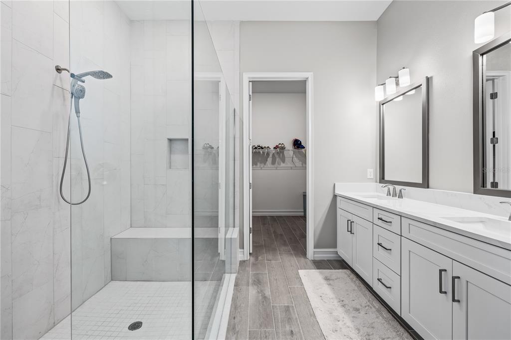 2632 Yellow Sundial Loop Ruskin, FL 33570 - Photo 28 of 52 a bathroom with a double vanity sink a toilet and shower