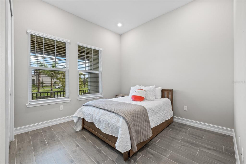 2632 Yellow Sundial Loop Ruskin, FL 33570 - Photo 32 of 52 a bedroom with a bed and a window