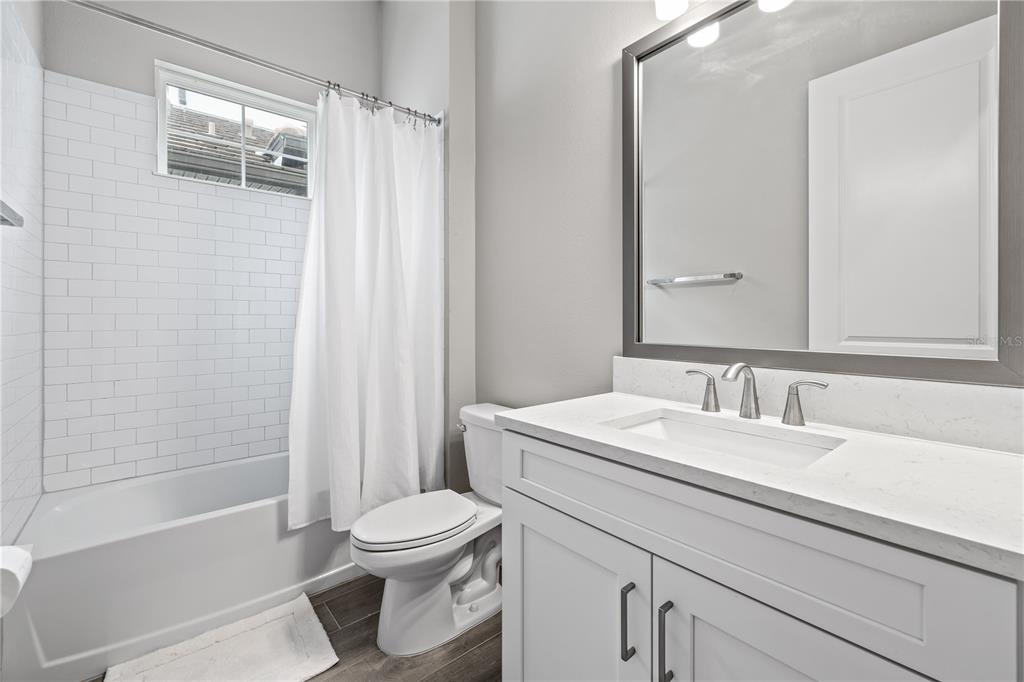 2632 Yellow Sundial Loop Ruskin, FL 33570 - Photo 34 of 52 a bathroom with a sink a toilet and shower