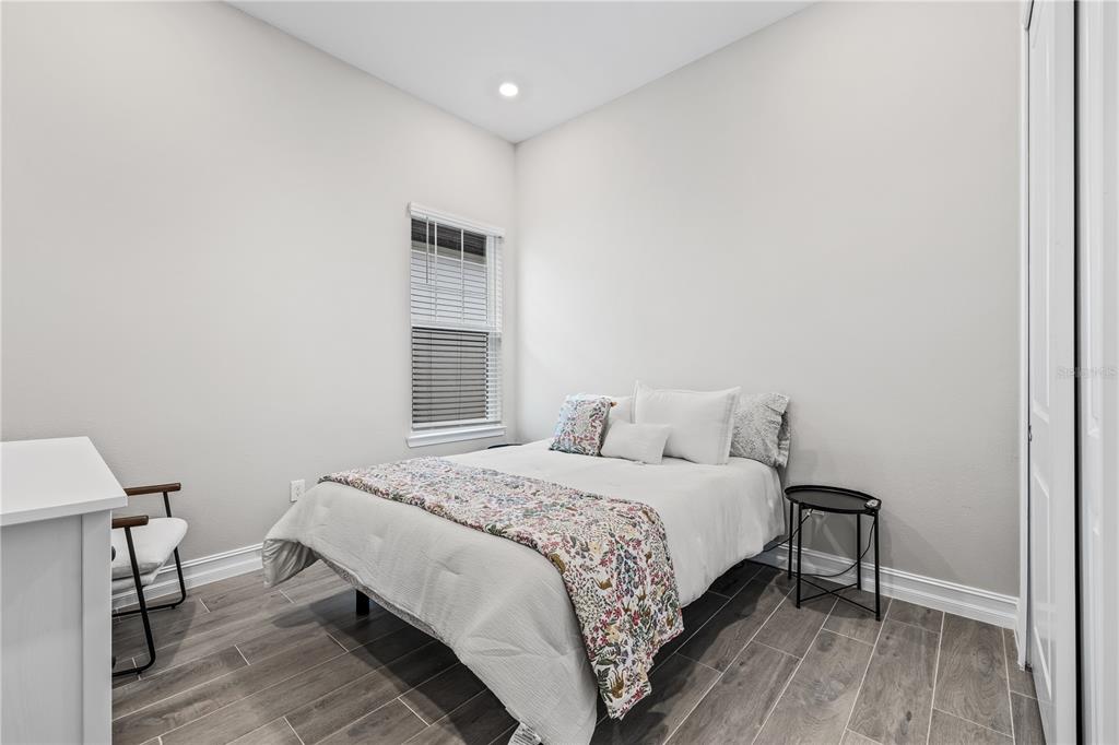 2632 Yellow Sundial Loop Ruskin, FL 33570 - Photo 35 of 52 a bedroom with a bed and a table in it