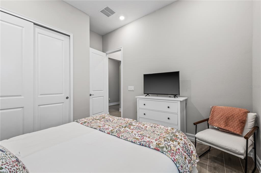 2632 Yellow Sundial Loop Ruskin, FL 33570 - Photo 36 of 52 a bedroom with a bed and a television