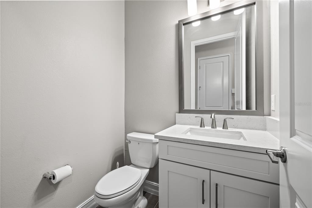 2632 Yellow Sundial Loop Ruskin, FL 33570 - Photo 37 of 52 a bathroom with a toilet sink vanity and mirror