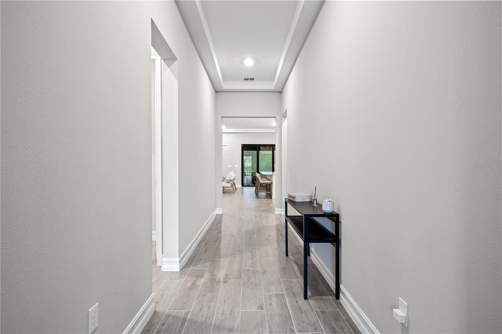 2632 Yellow Sundial Loop Ruskin, FL 33570 - Photo 7 of 52 a view of a hallway with wooden floor and staircase