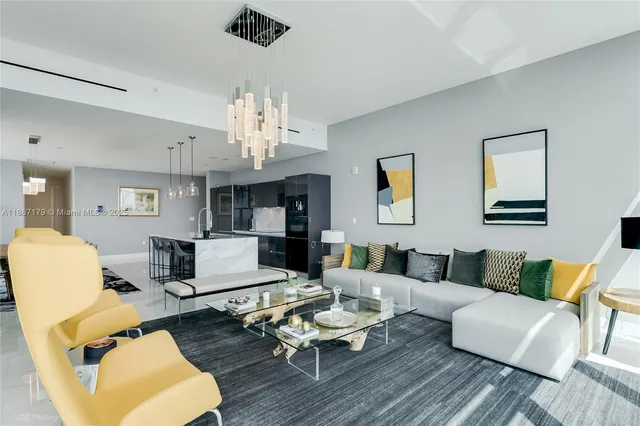 a living room with furniture or couch and a chandelier