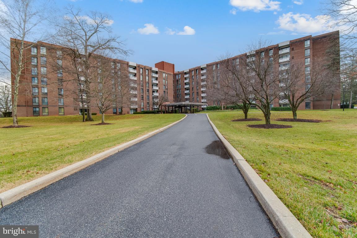 7 Slade Avenue, Unit 214 Pikesville, MD 21208 - Photo 1 of 24 a view of a building with a yard and a large window