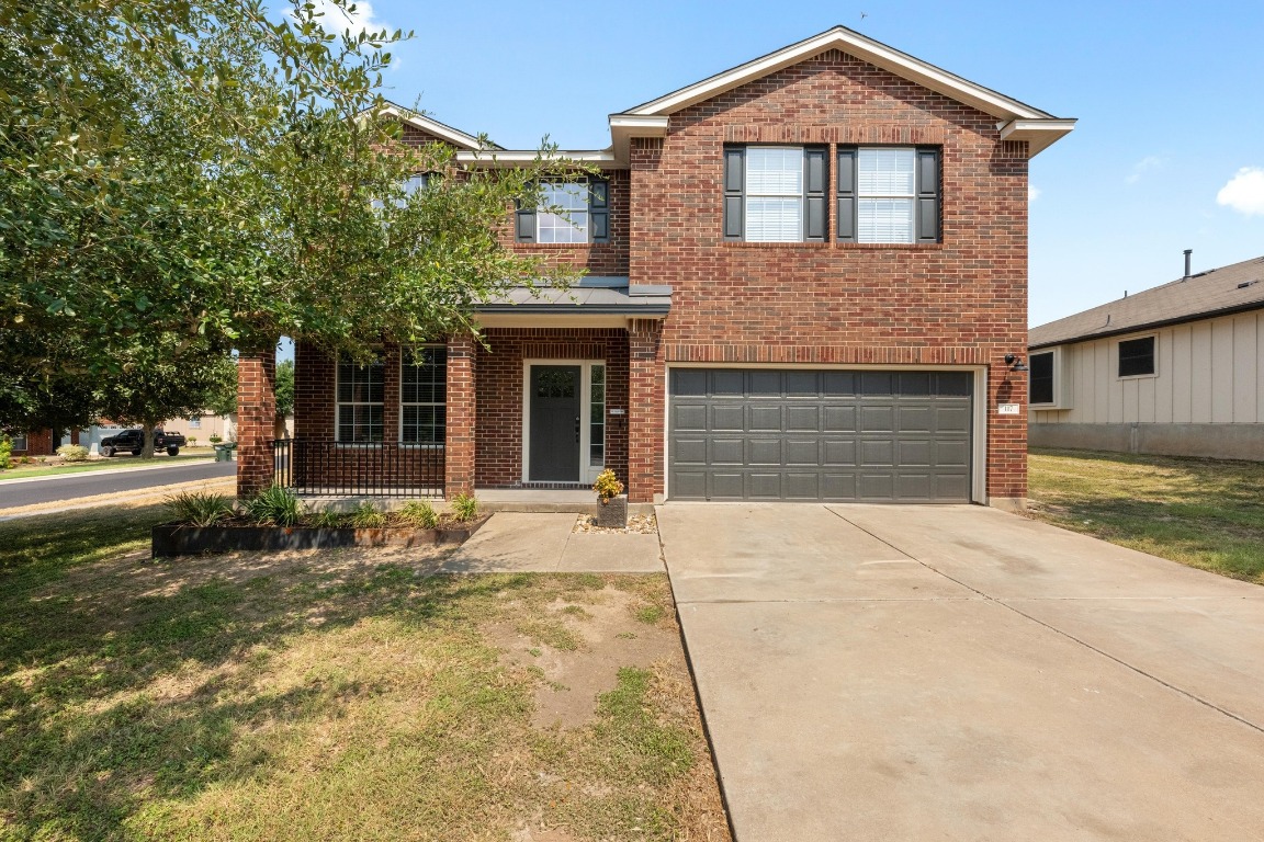 a front view of a house with a yard and garage