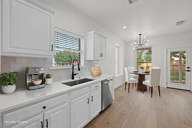 a kitchen with a sink and cabinets