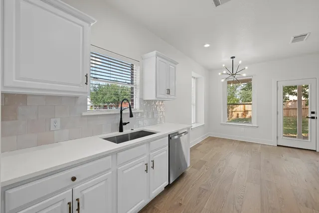 a kitchen with a sink and cabinets