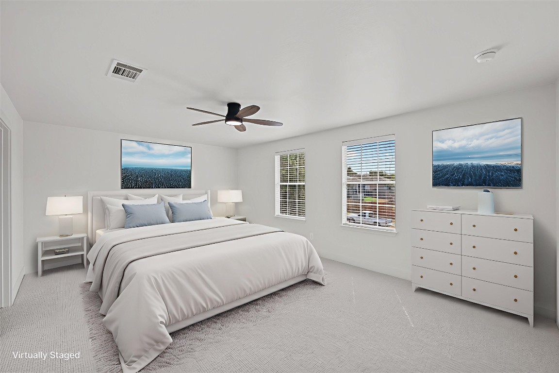 117 Waterloo Drive Kyle, TX 78640 - Photo 21 of 39 a bedroom with a large bed and a flat tv screen on dresser