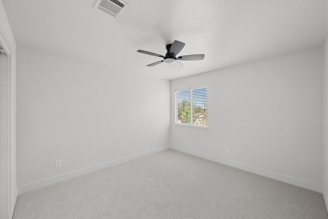 117 Waterloo Drive Kyle, TX 78640 - Photo 29 of 39 an empty room with a window and a fan
