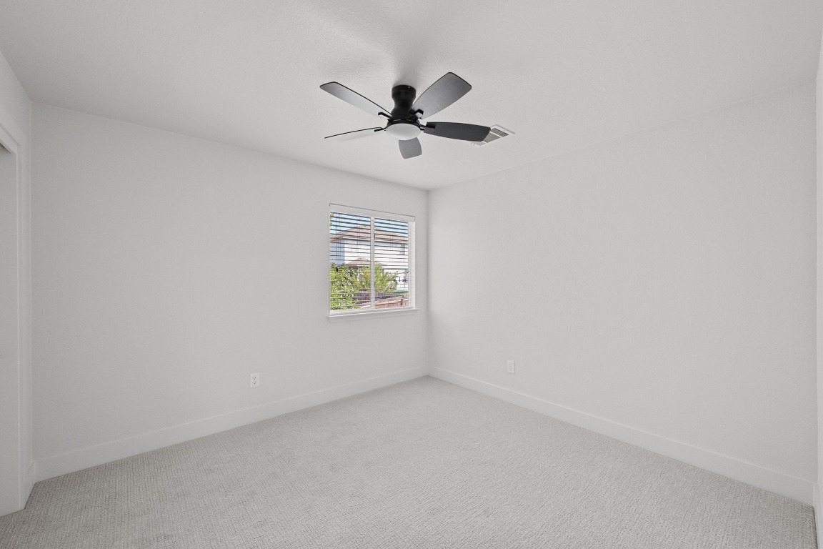 117 Waterloo Drive Kyle, TX 78640 - Photo 30 of 39 an empty room with windows and fan