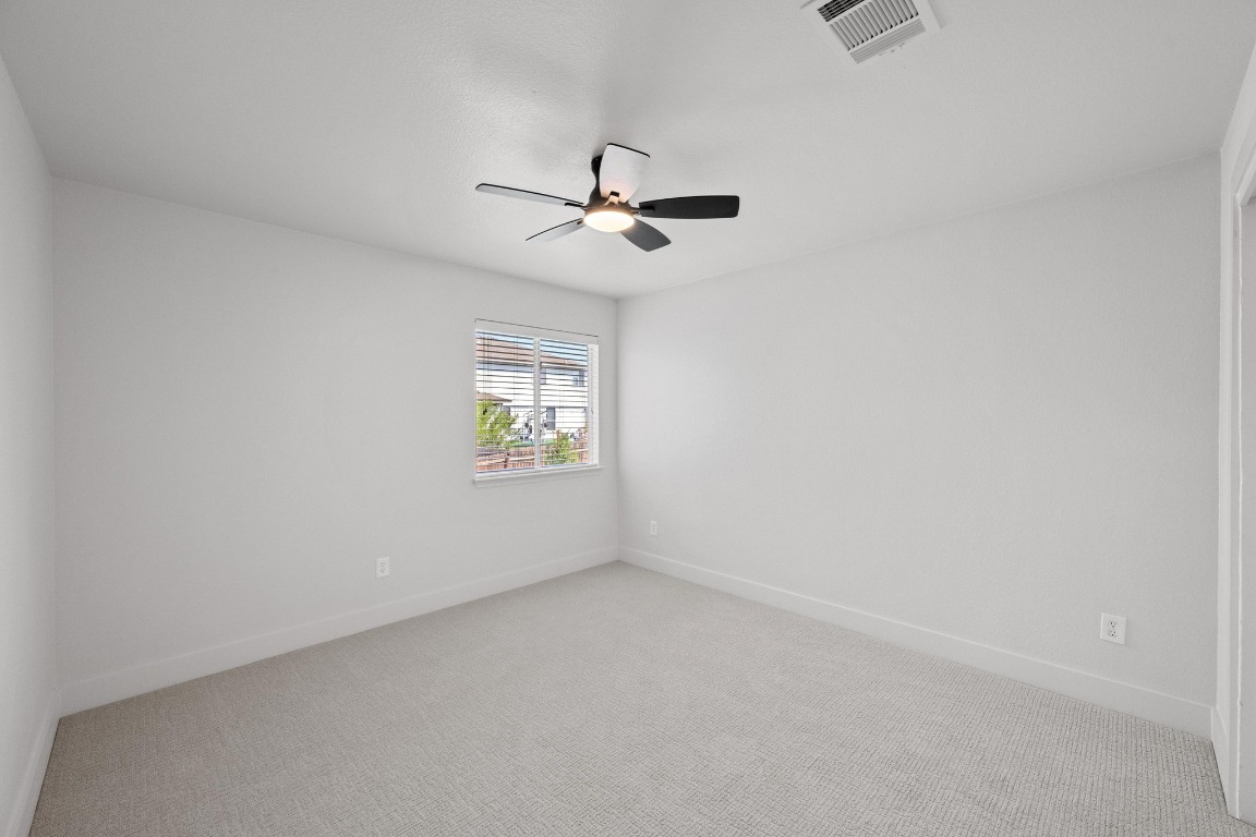 117 Waterloo Drive Kyle, TX 78640 - Photo 31 of 39 an empty room with windows and fan