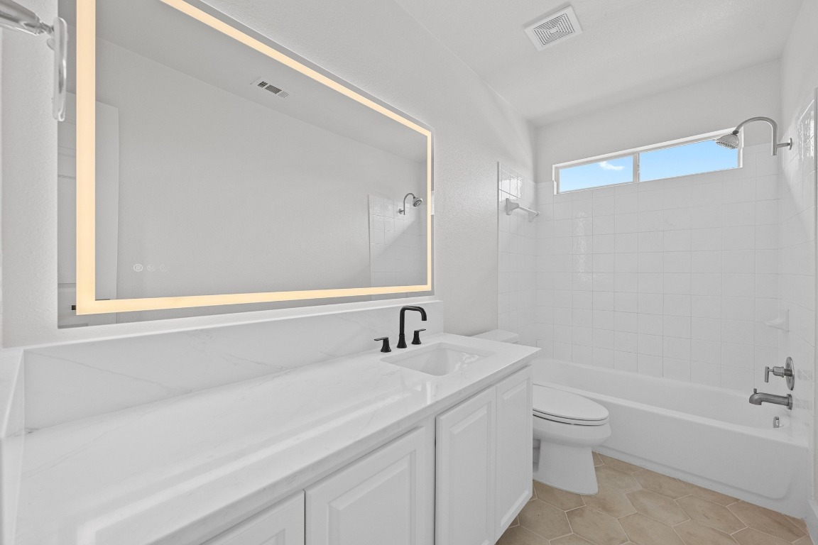 117 Waterloo Drive Kyle, TX 78640 - Photo 32 of 39 a bathroom with a sink a toilet and a bathtub