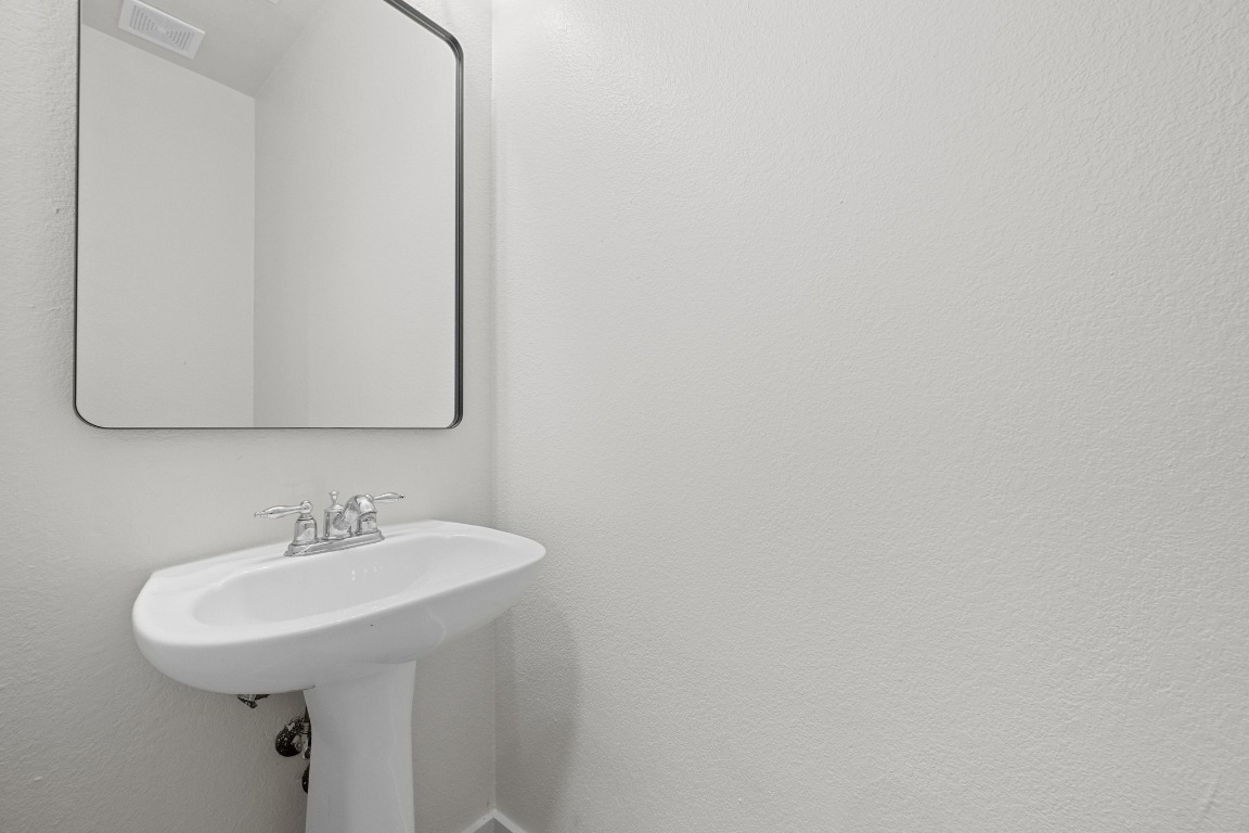 117 Waterloo Drive Kyle, TX 78640 - Photo 33 of 39 a bathroom with a sink and a mirror