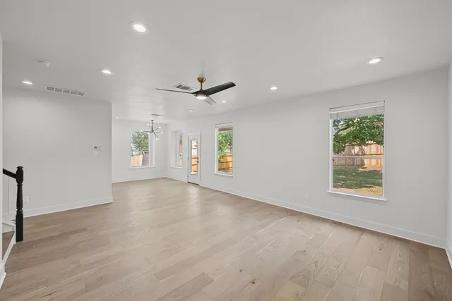 an empty room with windows and closet