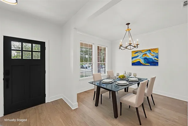a view of a dining room with furniture wooden floor and a chandelier
