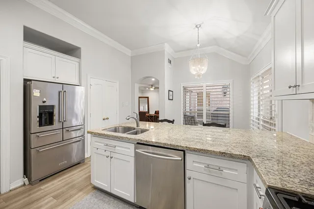 a kitchen with a sink stove and refrigerator