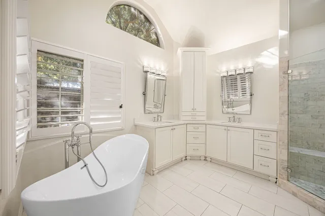 a bathroom with a granite countertop sink a washer and dryer