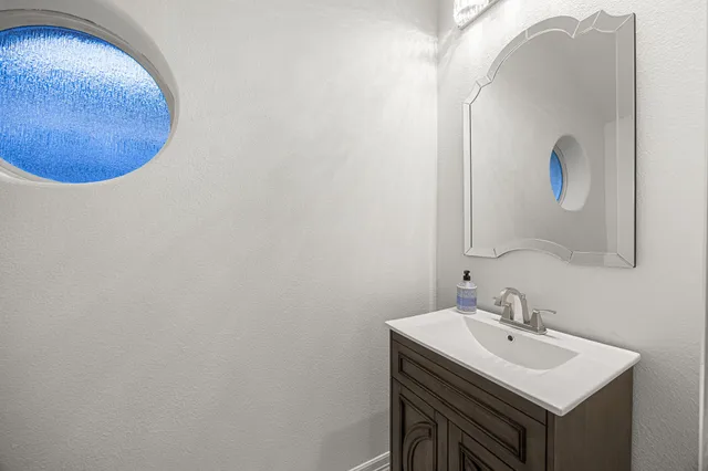 a bathroom with a sink and mirror