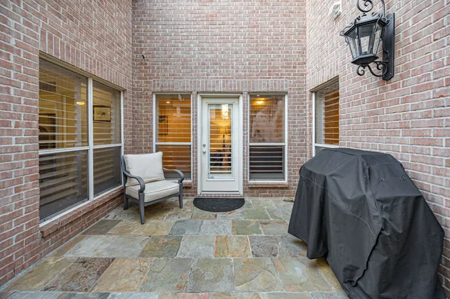 a view of a patio with chairs and a potted plant