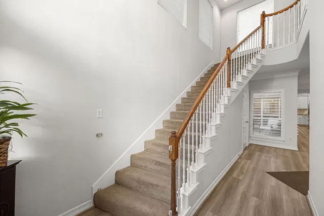 a view of entryway and hall with wooden floor