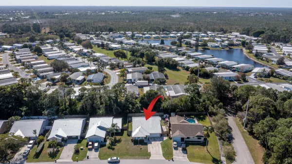 an aerial view of residential houses with outdoor space and river