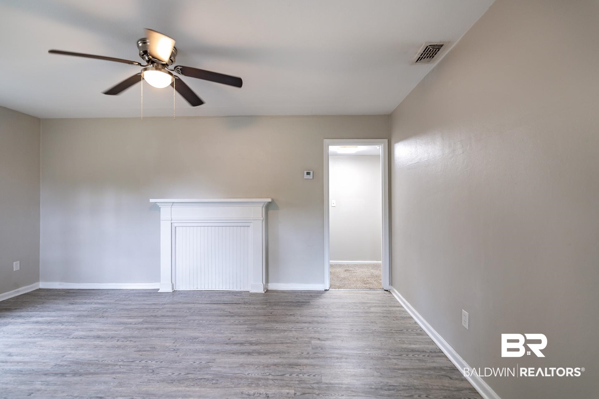 1869 Mott Drive West Mobile, AL 36617 - Photo 8 of 34 Unfurnished living room with baseboards, visible vents, wood finished floors, and a ceiling fan