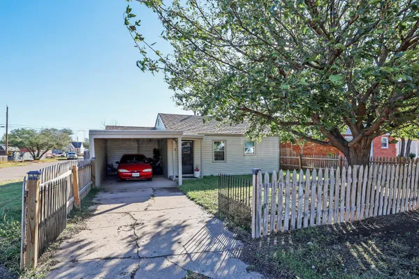 a view of a house with a yard and deck