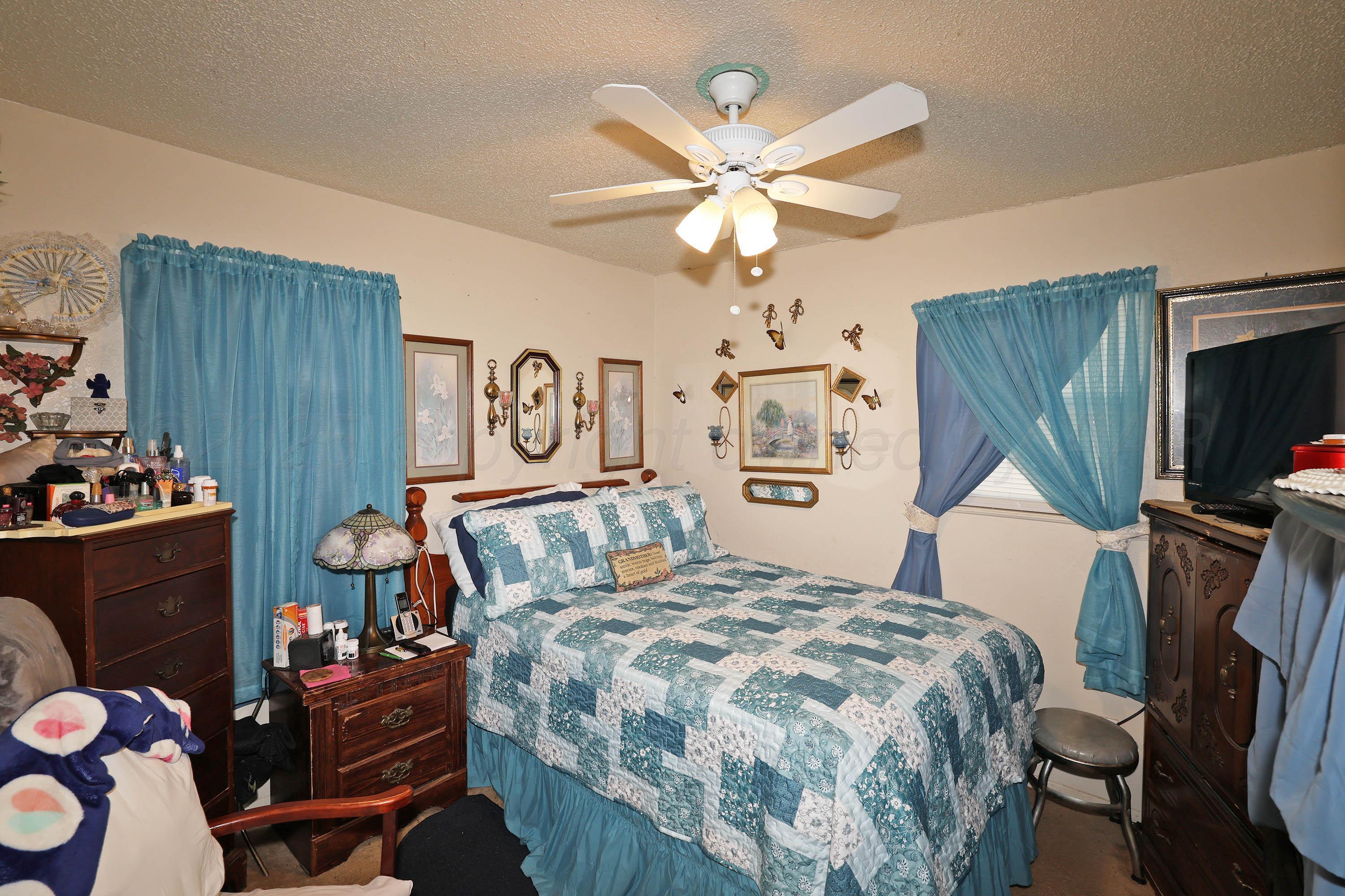 90 North Tennessee Street Amarillo, TX 79106 - Photo 11 of 22 a bedroom with a bed and furniture