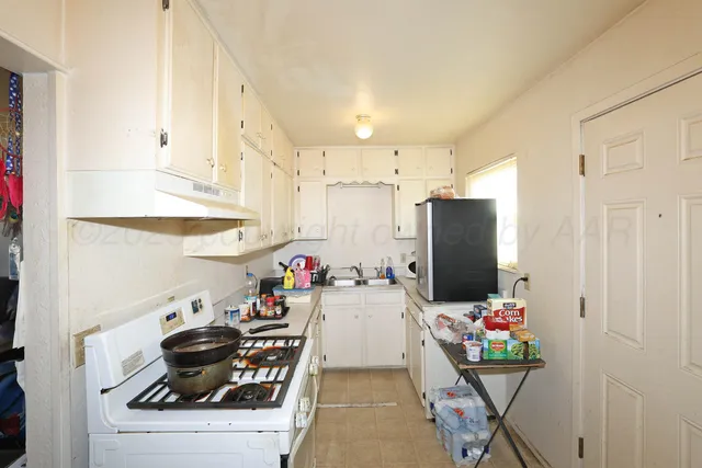 a kitchen with stainless steel appliances kitchen island granite countertop a refrigerator and a stove