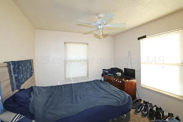 a bedroom with a bed and window