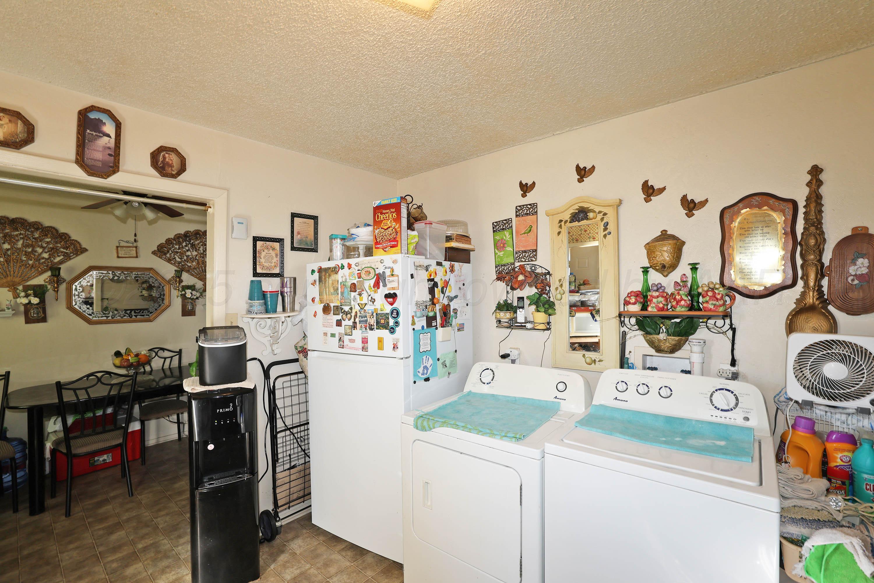 90 North Tennessee Street Amarillo, TX 79106 - Photo 7 of 22 a view of a kitchen with fridge and workspace