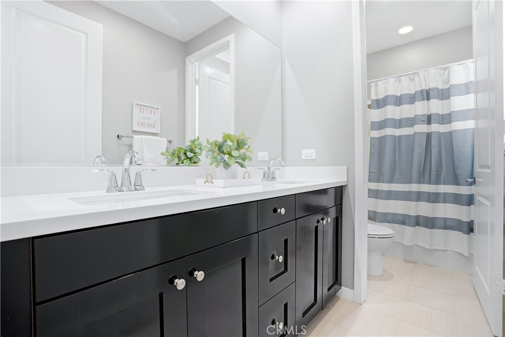 102 Marisol Street Rancho Mission Viejo, CA 92694 - Photo 28 of 75 a bathroom with a sink and a mirror