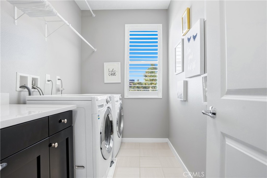 102 Marisol Street Rancho Mission Viejo, CA 92694 - Photo 33 of 75 a utility room with cabinets washer and dryer