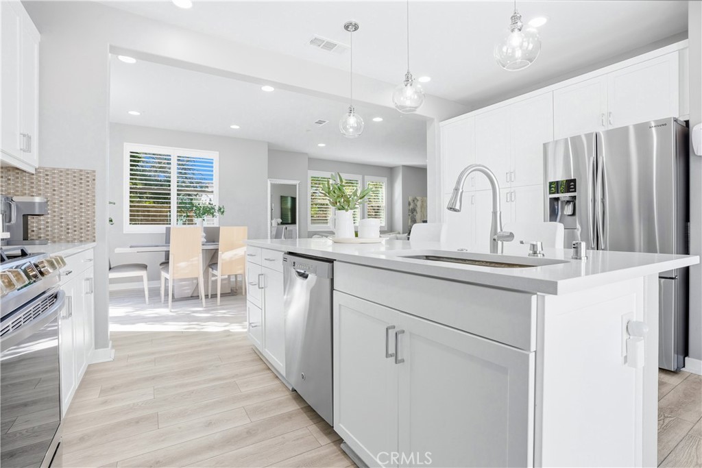 102 Marisol Street Rancho Mission Viejo, CA 92694 - Photo 4 of 75 a living room with stainless steel appliances kitchen island furniture and a large window