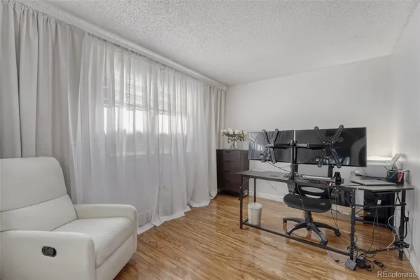 a living room with furniture and wooden floor