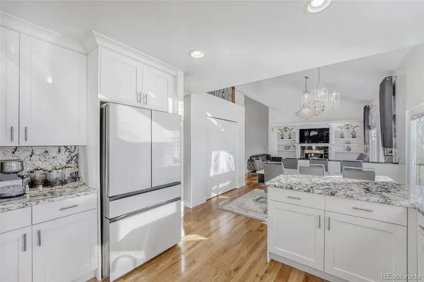 a kitchen with kitchen island a counter top space appliances and cabinets