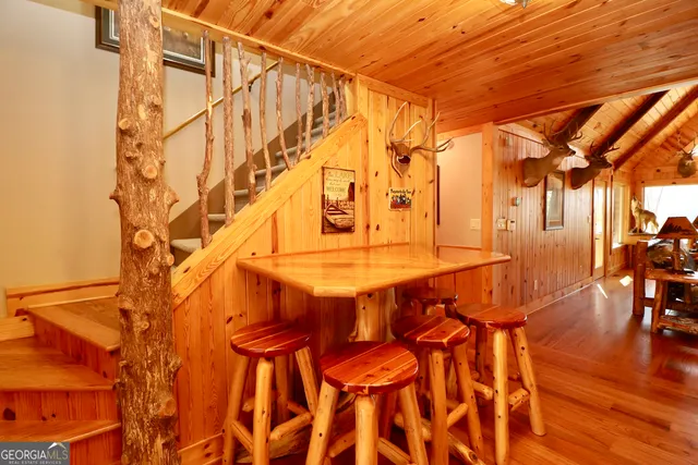 a dining room with a table and chairs with wooden floor