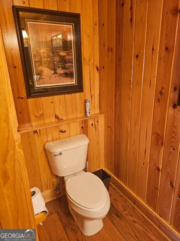 a roof deck with wooden floor and fence