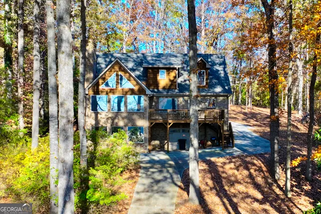 a view of a house with a tree and a yard